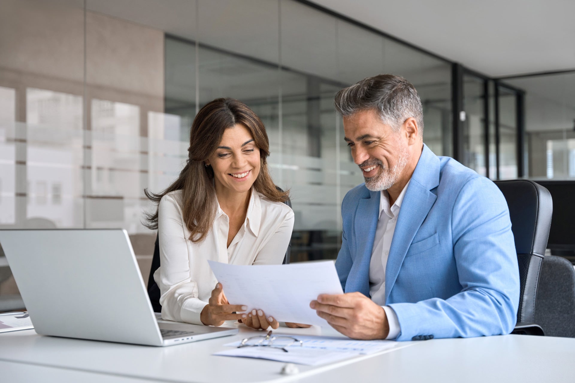 two persons infront of a laptop