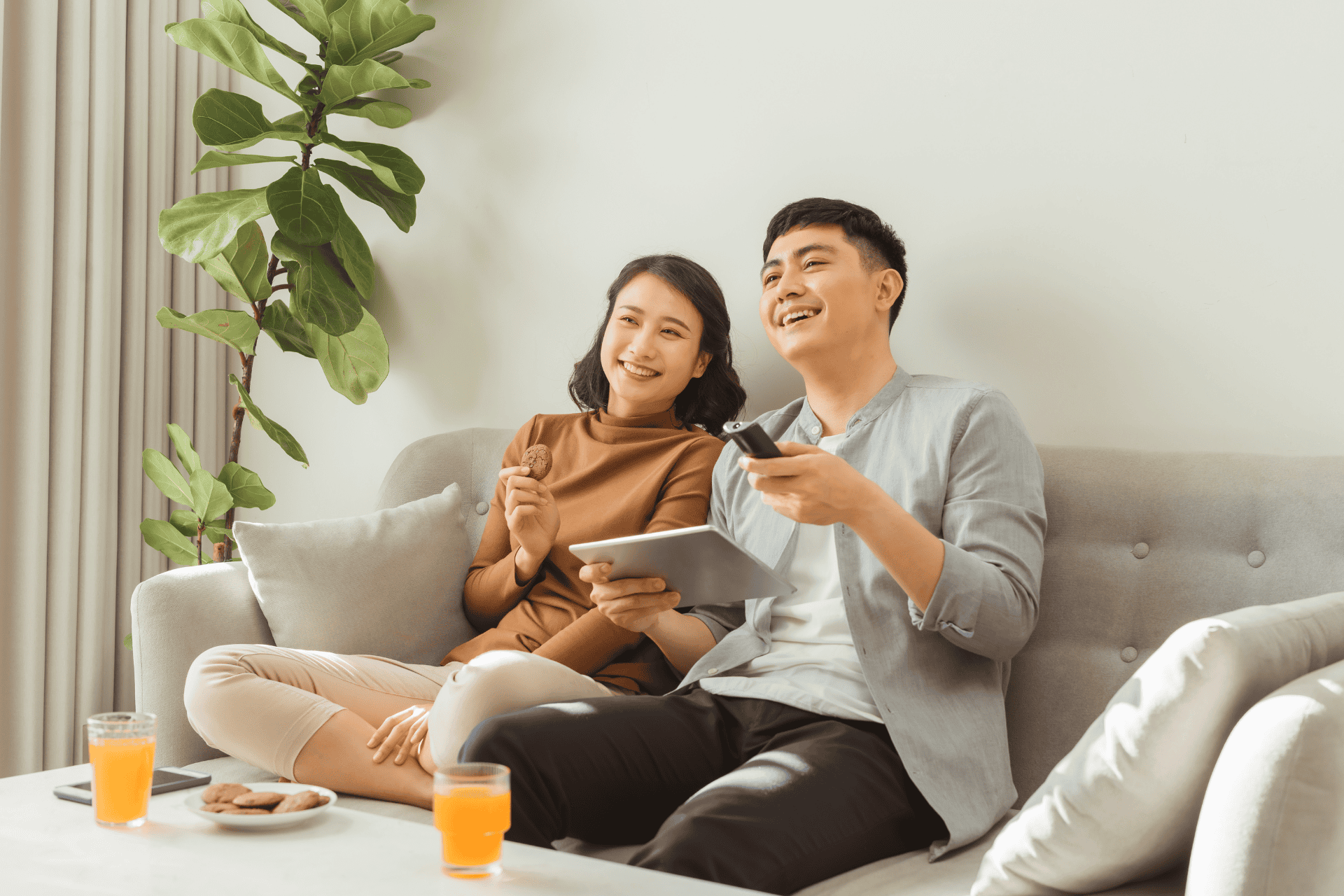 A couple watching TV on a sofa