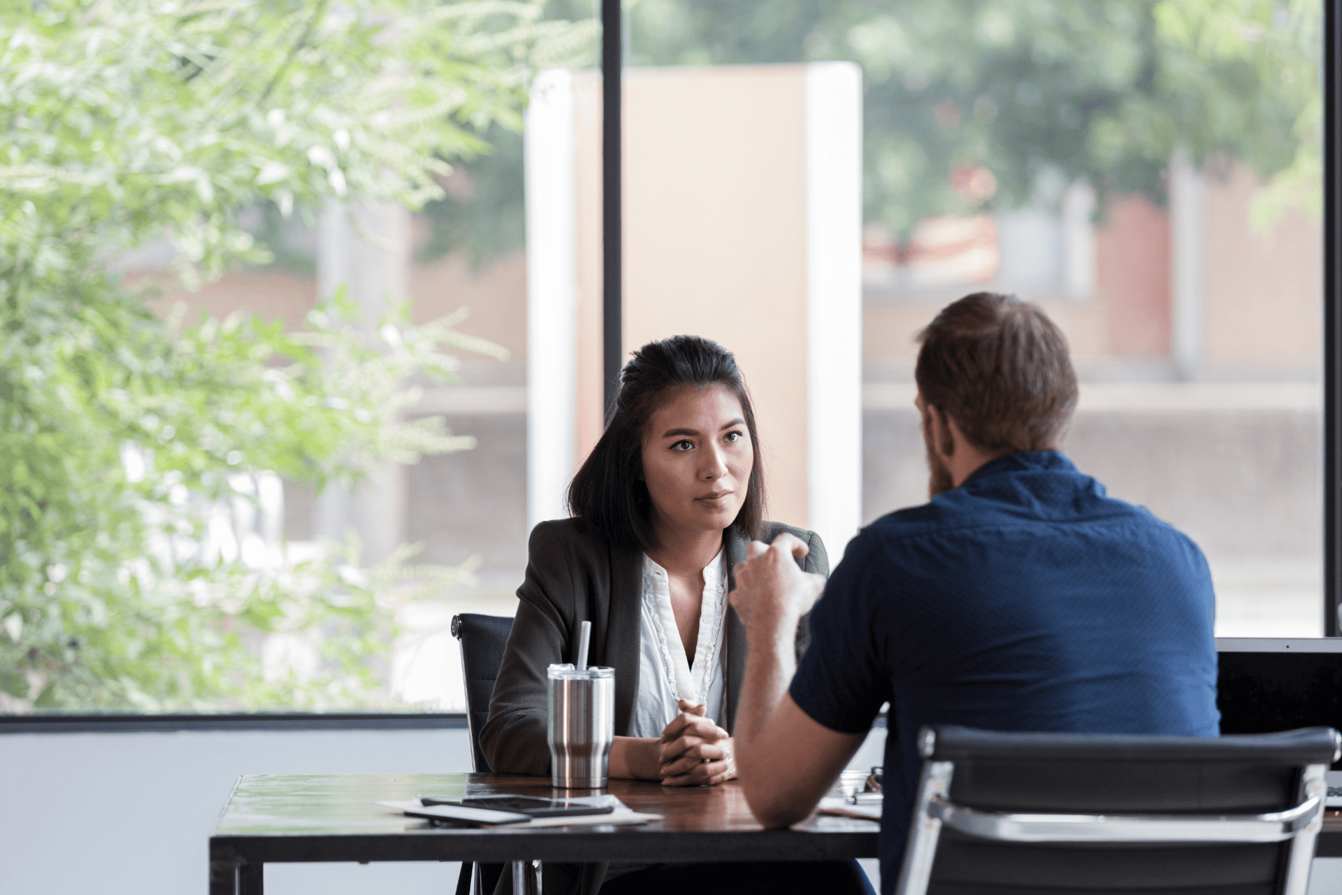 Two coworkers are fully present in a conversation