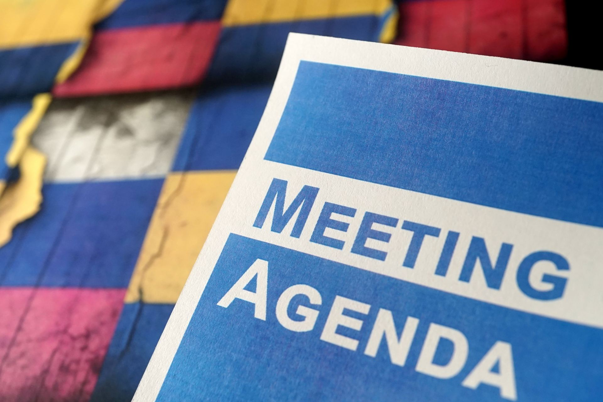A printed copy of a team meeting agenda