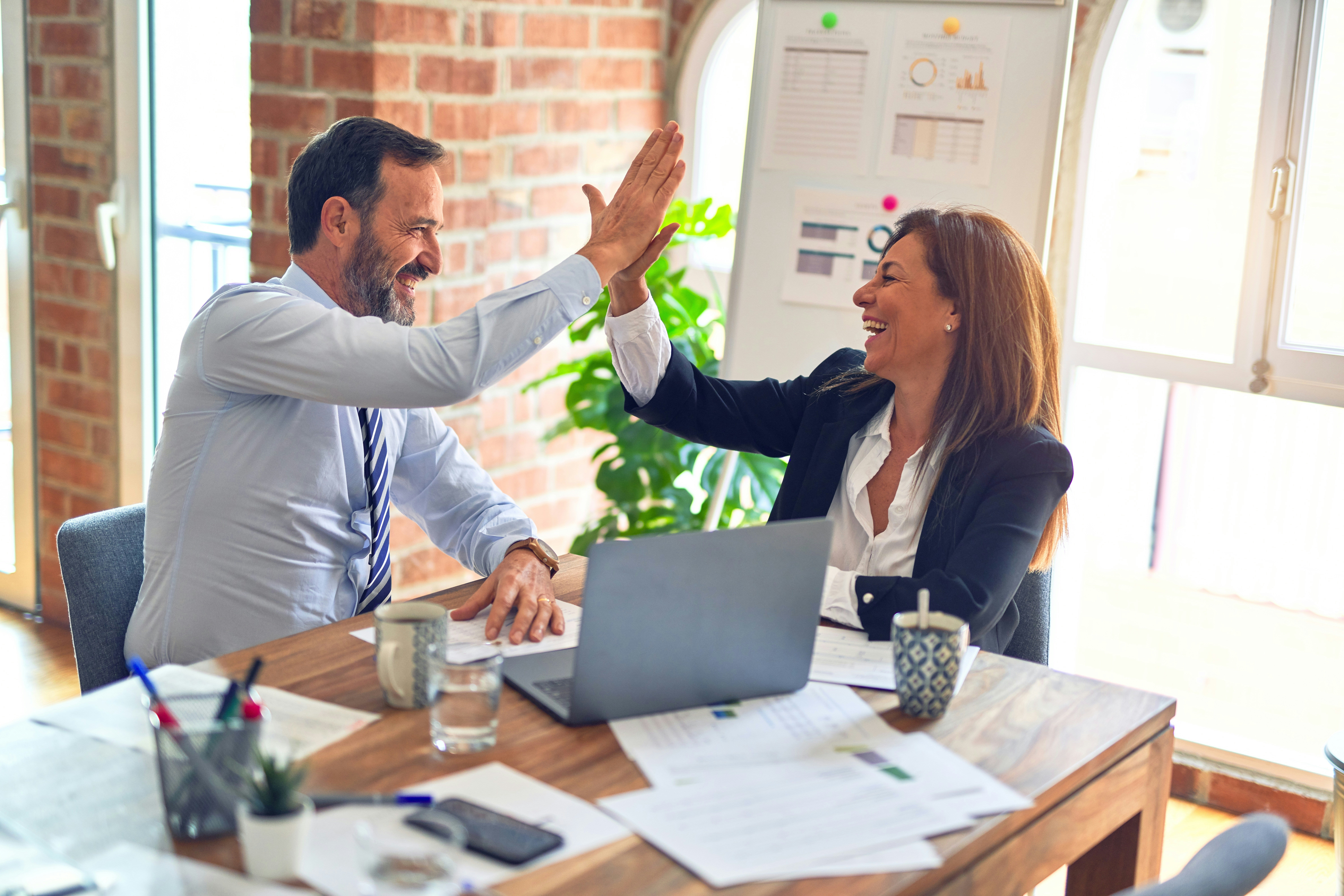 High five between colleagues at the office