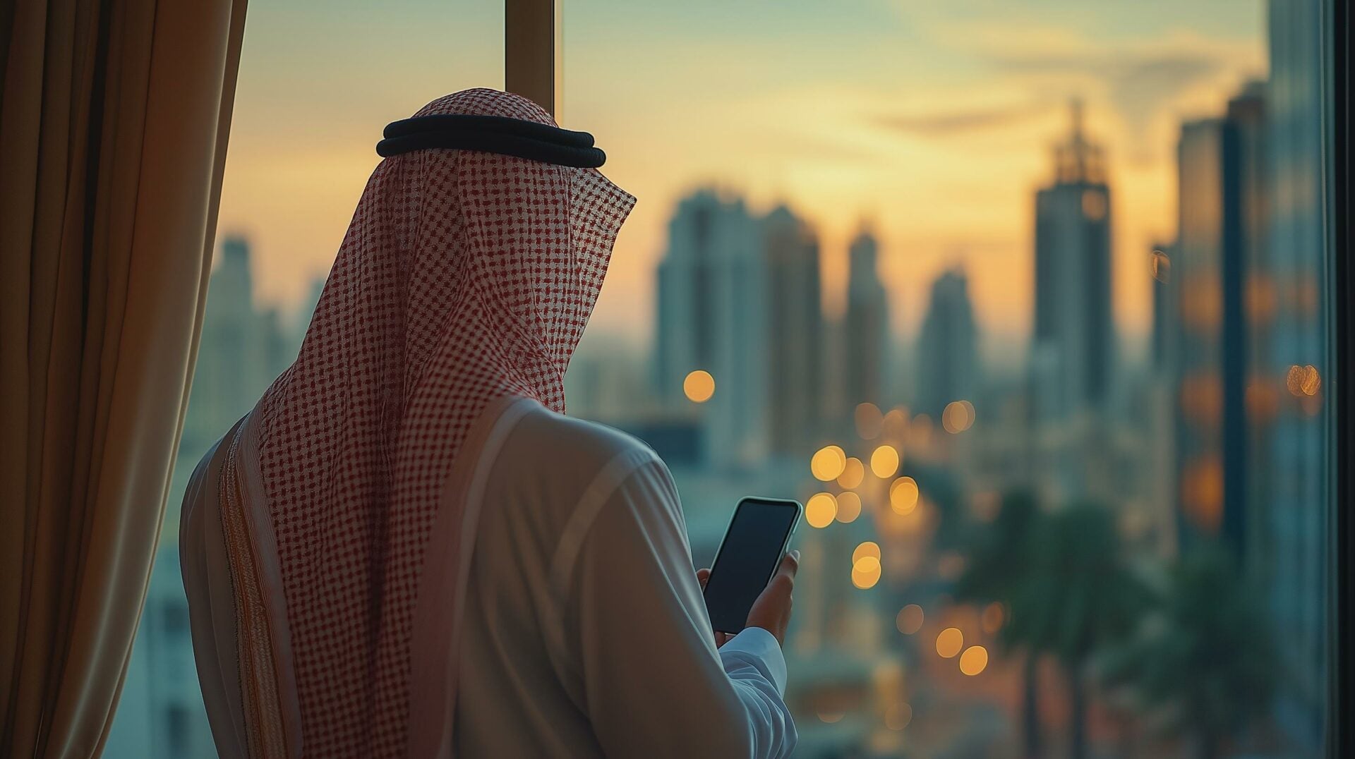 Saudi professional looking at his phone